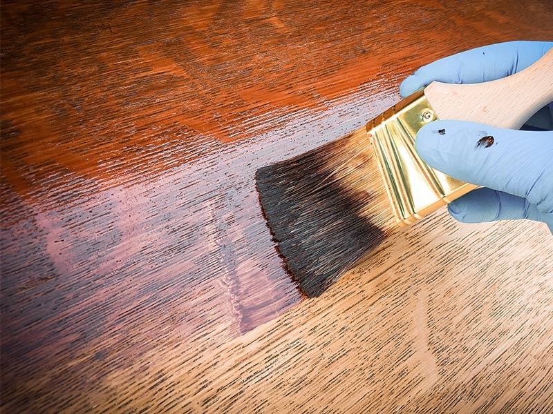 close up of a contractor staining recently refined hardwood flooring lawndale ca