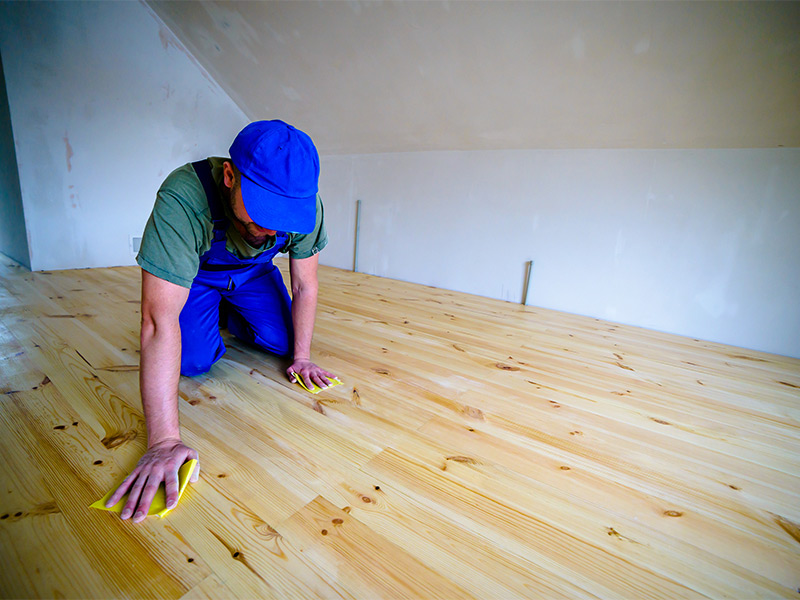 worker cleaning hardwood flooring after installation lawndale ca